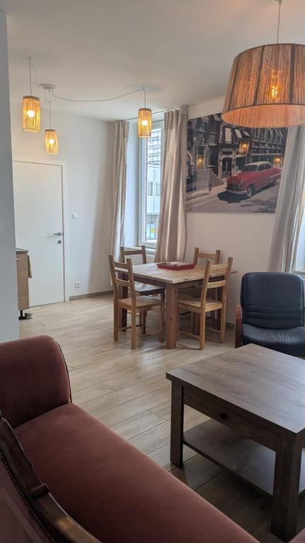 a living room with a table and chairs at Liège City break in Liège