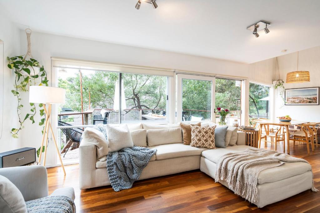 a living room with a couch and a table at Surf Haven in Lorne