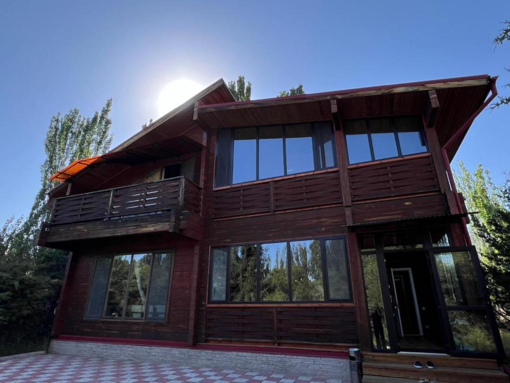 a large wooden house with a balcony on top at Семейный коттедж in Bulan Sogottuu