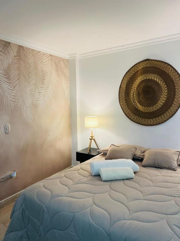 a bedroom with a large bed with a large painting on the wall at Casa Ligia in Medellín