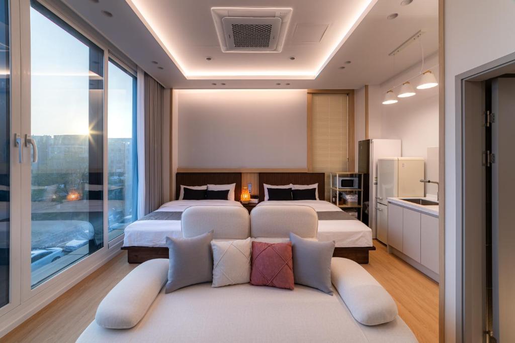 a bedroom with two beds and a couch at STAY On-A in Seoul