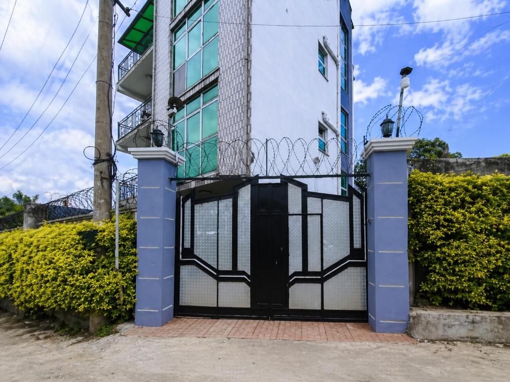 a building with a gate on the side of it at Keba Guest House - Addis Ababa in Addis Ababa
