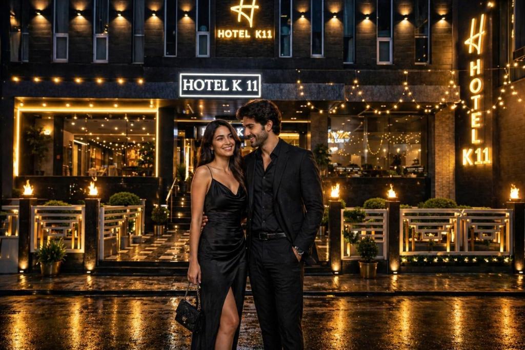 a man and a woman standing in front of a building at Hotel k11 in Solan