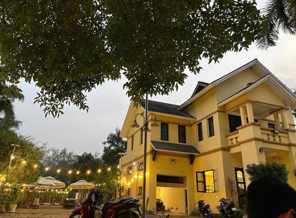 a house with motorcycles parked in front of it at Homestay Mẹ Mít in Cu Chi