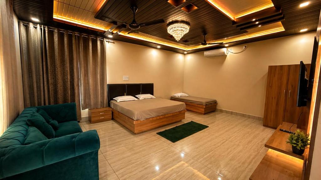 a bedroom with a bed and a couch in a room at M2LambardaarStay in Kandogal