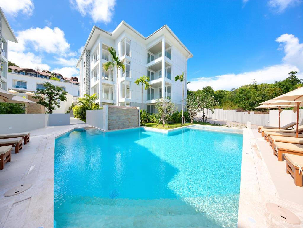 an image of a swimming pool in front of a building at Horizon Residence Rentals in Choeng Mon Beach