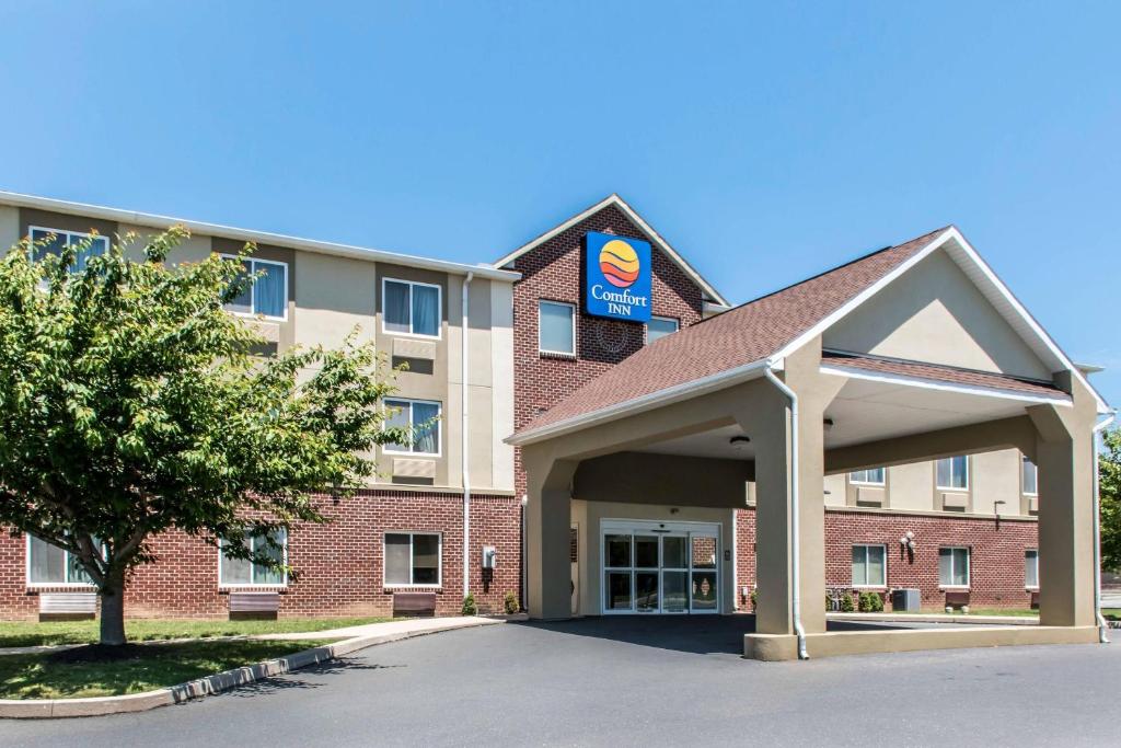 a large red brick building with a sign on it at Comfort Inn Lancaster County in Columbia
