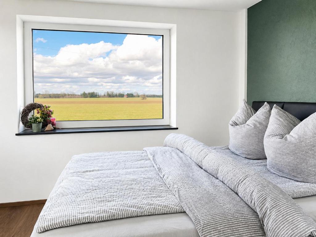 a bedroom with a window with a view of a field at Apartment Ihm in Memmingen