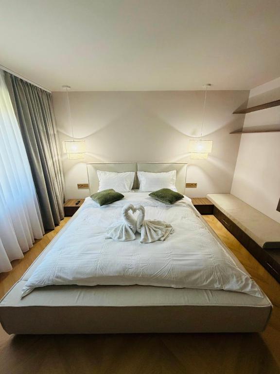a bedroom with a large bed with an angel on it at Vega House Luxury & Relax in Orşova