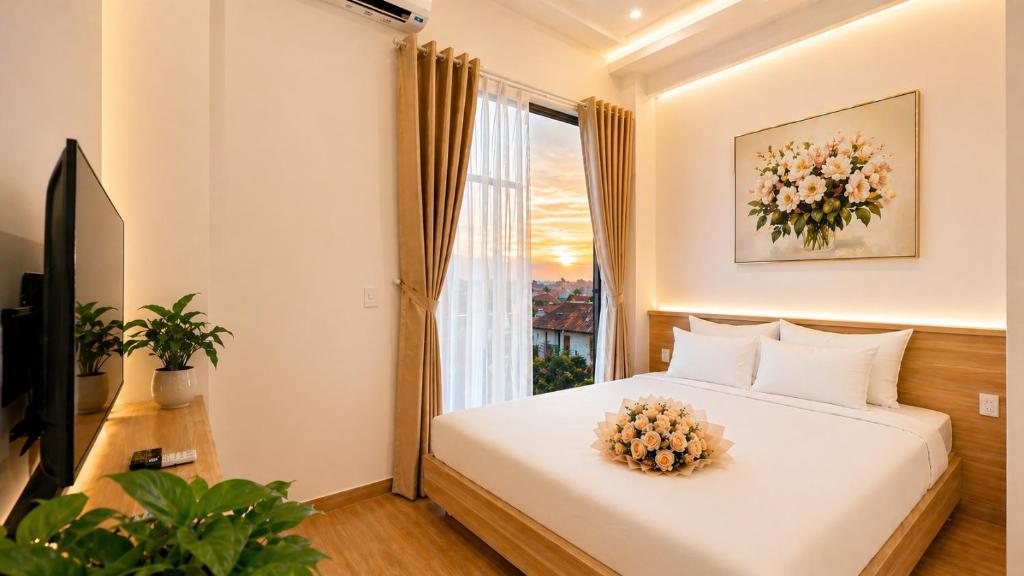 a bedroom with a white bed and a window at Amory Airport Hotel in Ho Chi Minh City