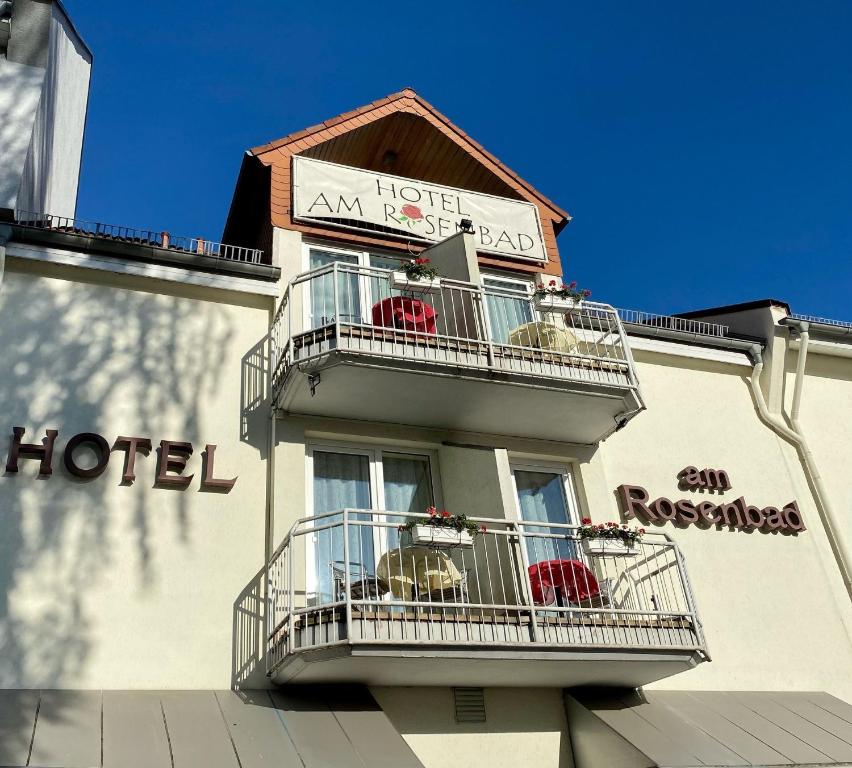 a building with balconies and a hotel sign on it at Hotel am Rosenbad in Fulda