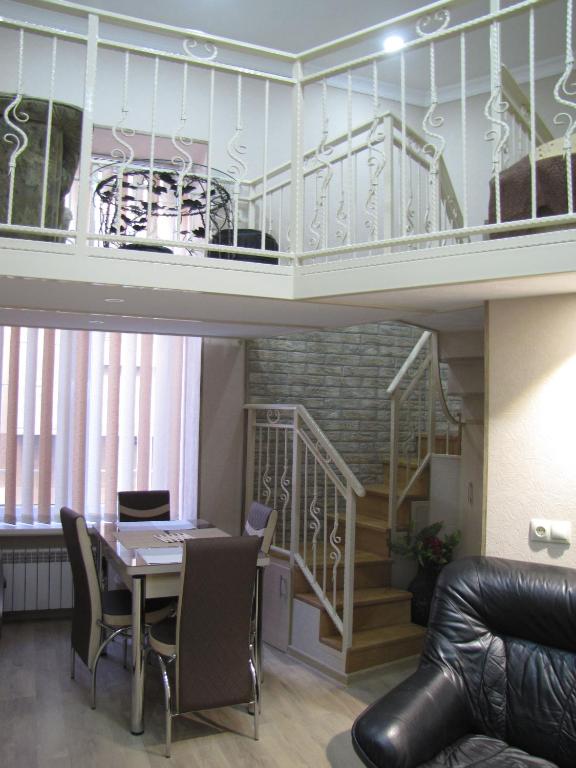 a living room with a table and a staircase at Inna`s Studio in Tbilisi City