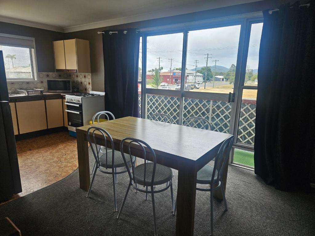 a kitchen with a table and chairs and a large window at Rockhampton Court Apartment in Rockhampton