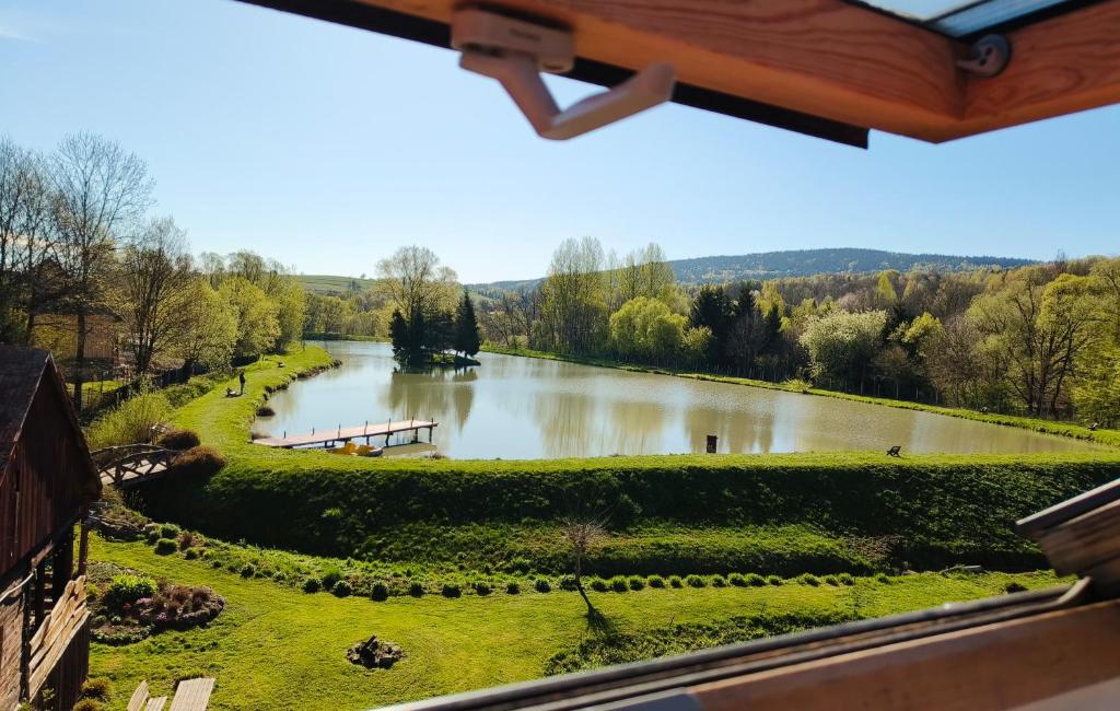 a view of a river from a building at Na Stawach in Stryszów