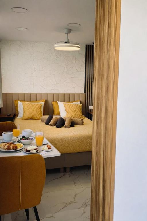 a bedroom with a bed and a table with food on it at Las Americas Prime Suite Spot in Costa de Adeje
