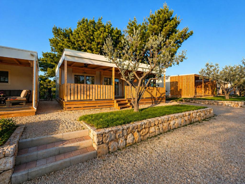 a house with a tree in front of it at Aurea Lux in Pakoštane