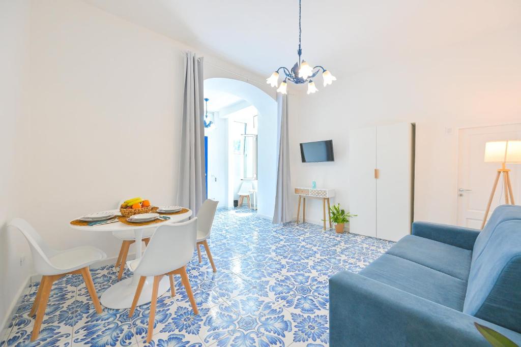 a living room with a blue couch and a table at La Casa del Mozzo in Ischia