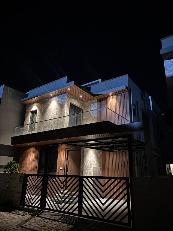 a building with a fence in front of it at night at Sai Sea Groups in Covelong