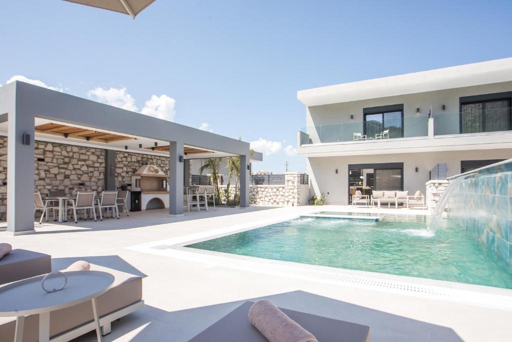 an image of a villa with a swimming pool at Calma Luxury Villas in Kolymbia