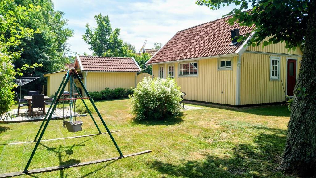 a yard with a house and a swing at DeLay's Guest House in Ängelholm