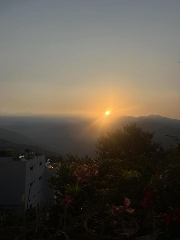 a sunset from the top of a building at Subhechchha Hotel in Charikot