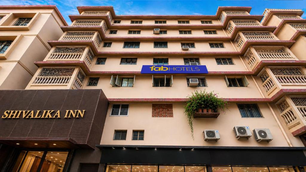 a building with a sign on the side of it at FabHotel Sivalika Inn - Howrah in Kolkata