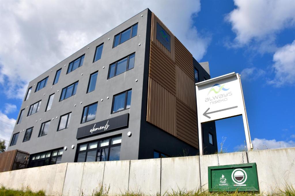 a building with a sign in front of it at Always Niseko in Kutchan