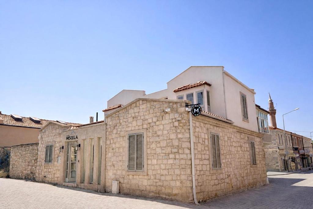 an old brick building on the side of a street at Studio Miscela in Urla