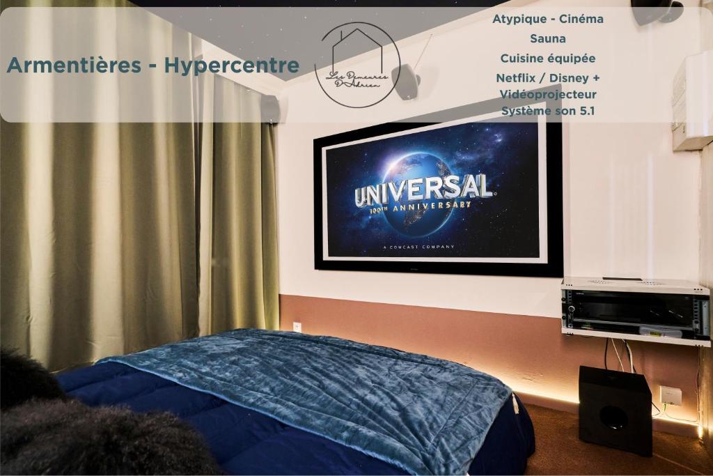 a tv on a wall with a movie projected on it at Cinéma Privé & Sauna - Nuit Romantique in Armentières