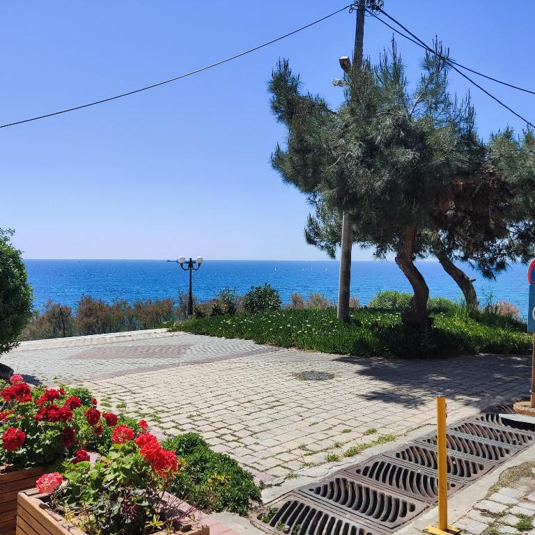 a stone walkway with a view of the ocean at Serene Vintage in Nea Moudania