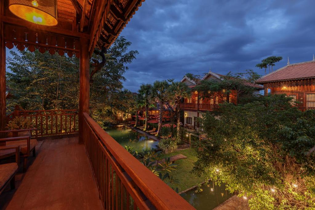 a view from the balcony of a resort with a pond at Dontrei Villa Angkor in Siem Reap