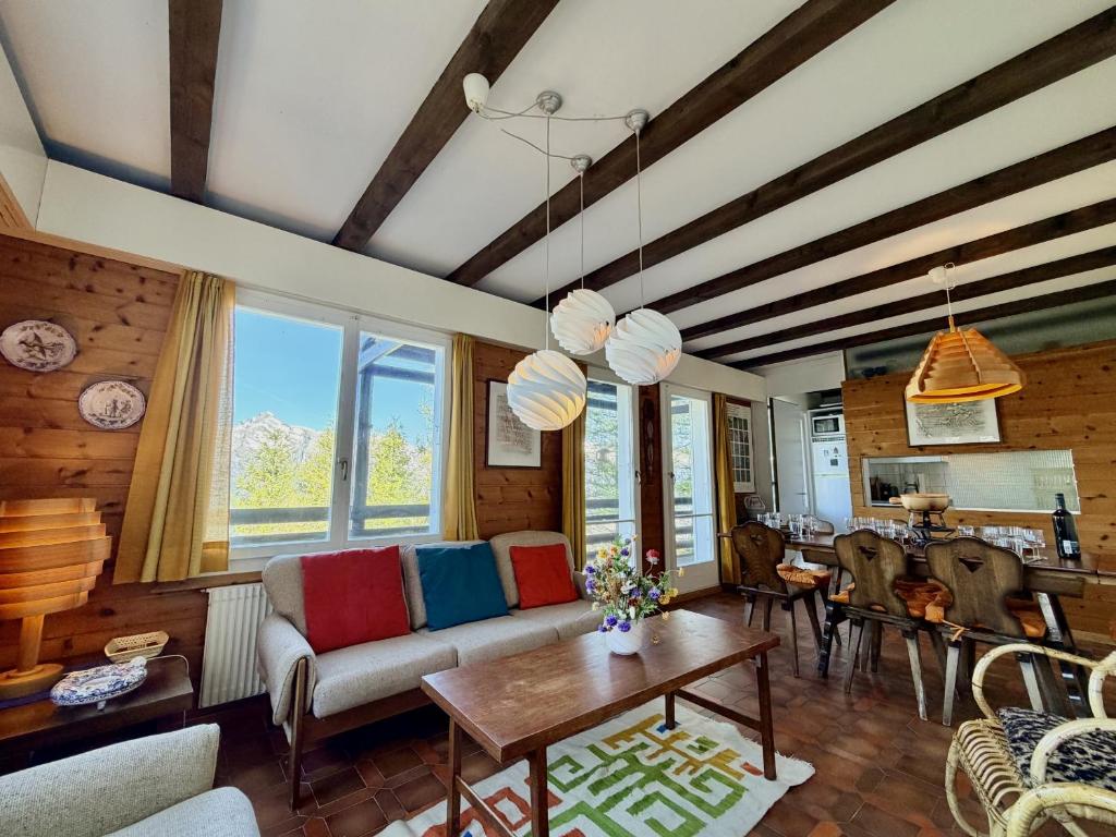 a living room with a couch and a table at Cache-Cache MOUNTAIN & QUIET chalet 10 pers in Veysonnaz