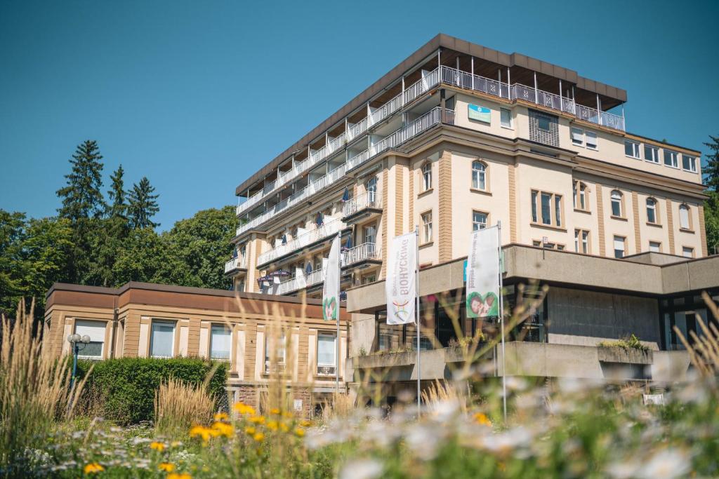 a building with flowers in front of it at LU8 Business Vital Hotel in Bad Dürrheim