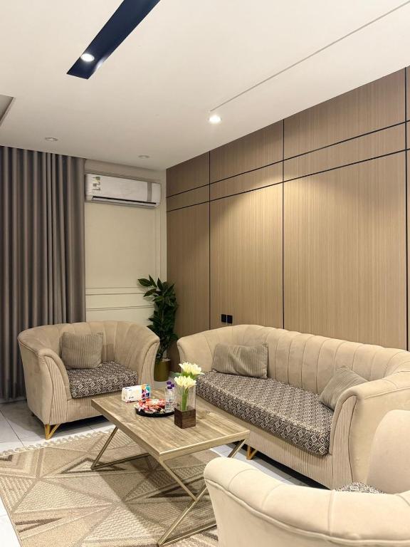 a living room with two couches and a table at رُقيّ للشقق الفندقية rogy VIP in Taif