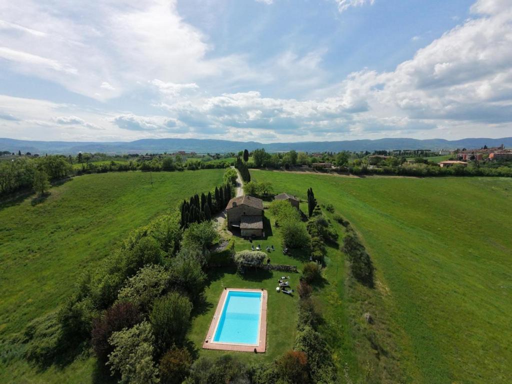 an aerial view of a large green field with a swimming pool at Podere Cartaio Bio Farm, private pool, AirC in San Rocco a Pilli