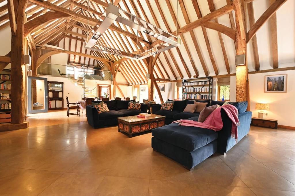 a large living room with couches in a building at The Manor Barn in Canterbury