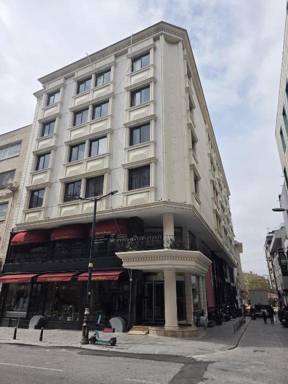 a tall white building on a city street at The Parma Hotel Downtown in Istanbul