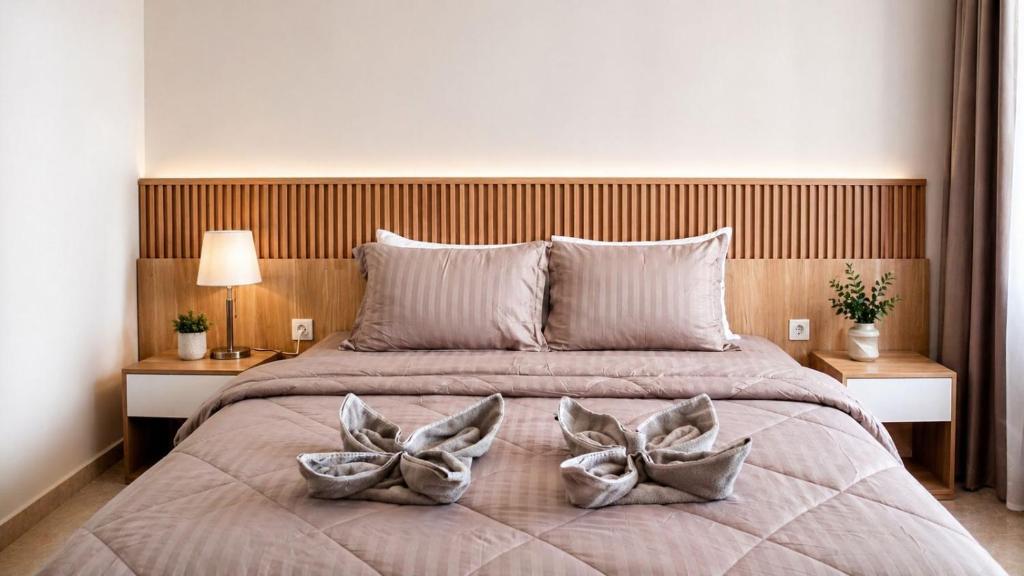 a bedroom with a large bed with two pillows at Pantai Ayu Homestay in Padangbai
