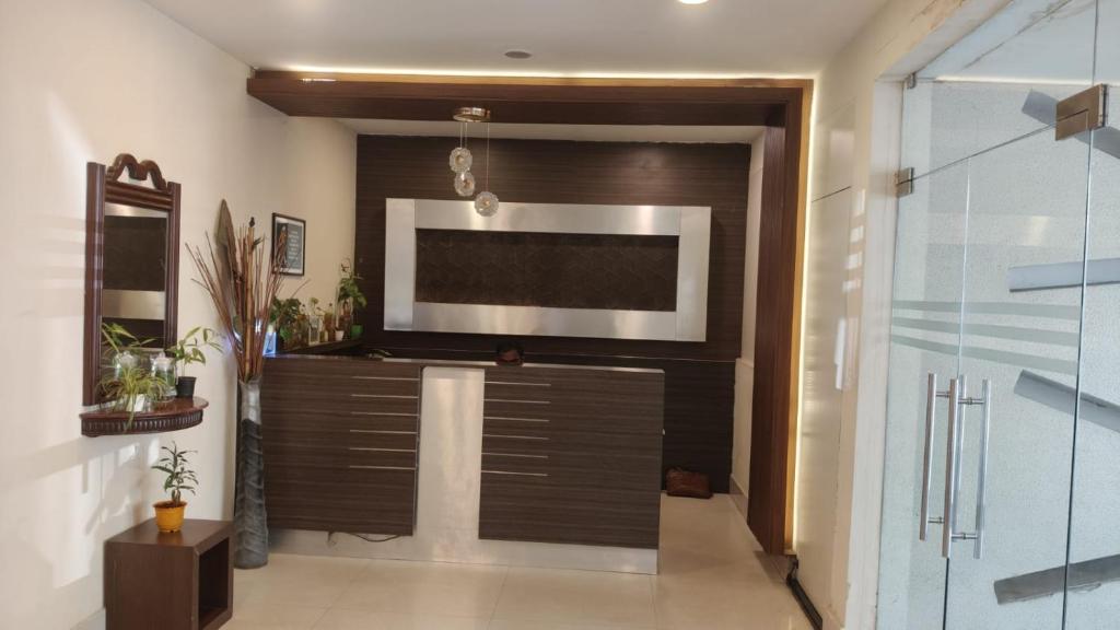 a living room with a flat screen tv on a wall at Hotel Blu Ivy in Chennai
