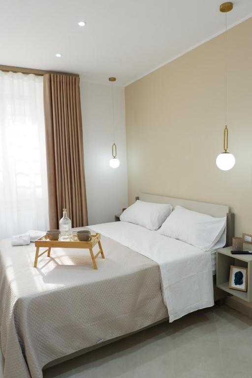 a bedroom with a large bed with a table on it at Dimora Don Ferdinando in Naples