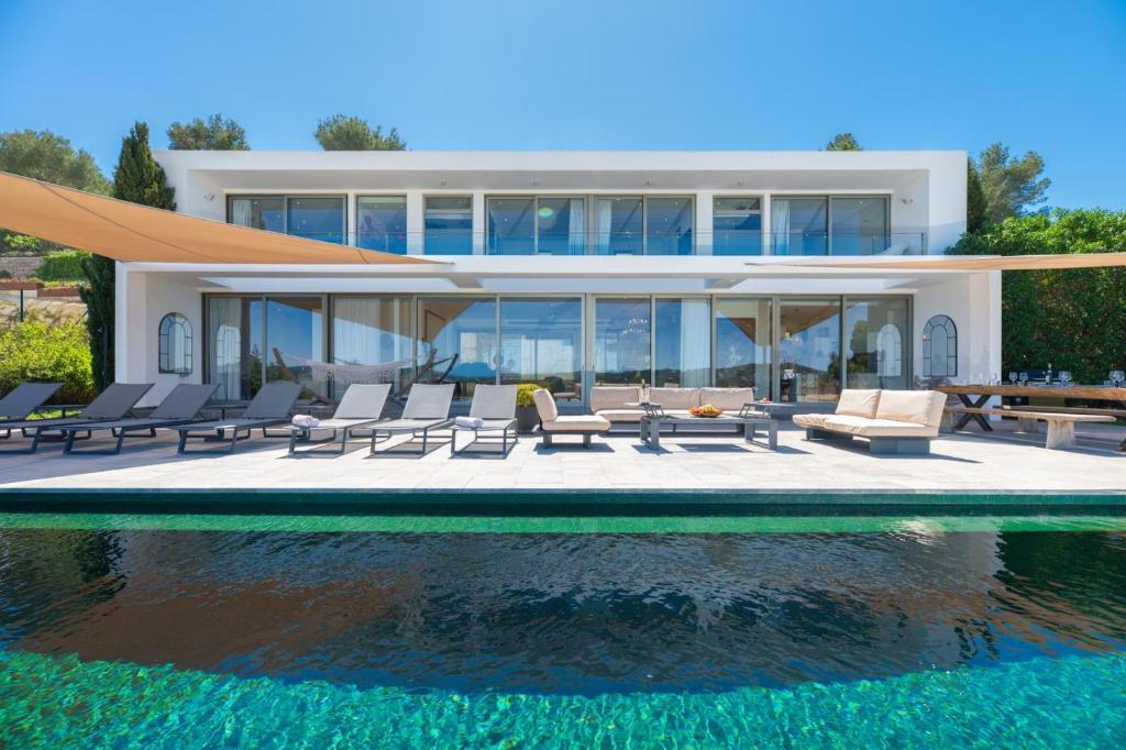 a house with a pool in front of it at Villa Roca Llisa in Santa Eularia des Riu