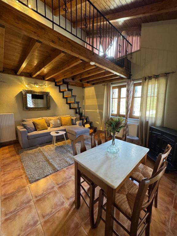 a living room with a table and a couch at Frigias 4 in Arachova