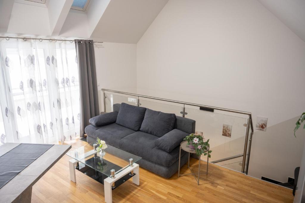 a living room with a couch and a table at Paky Appartements 00323 in Bruck an der Leitha