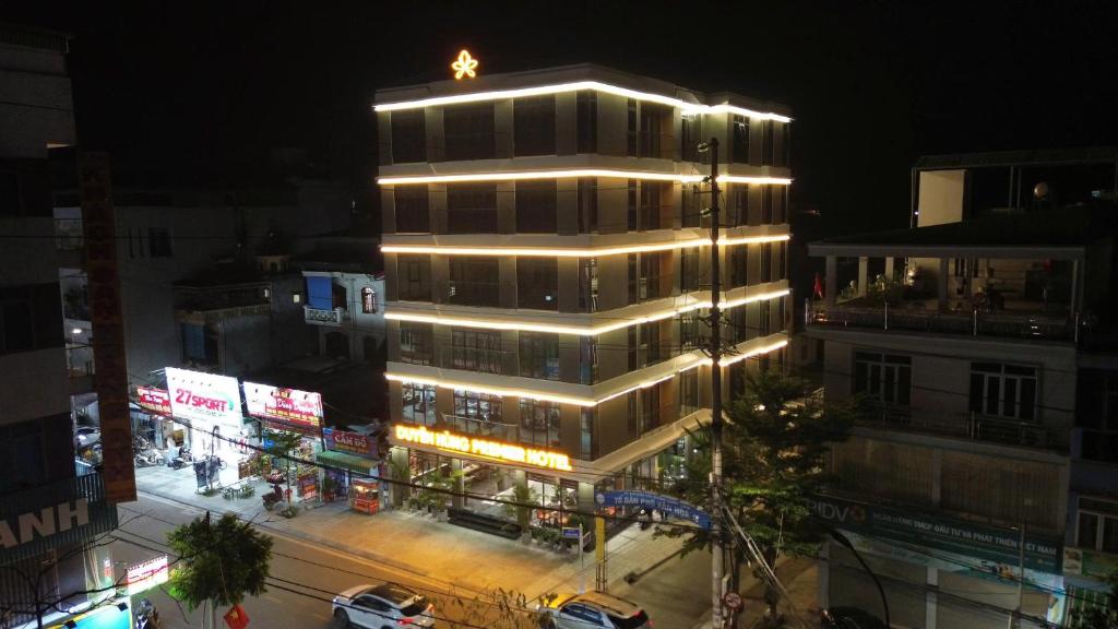 a tall building with lights on top of it at night at Duyên Hùng Premier Hotel in Diện Biên Phủ