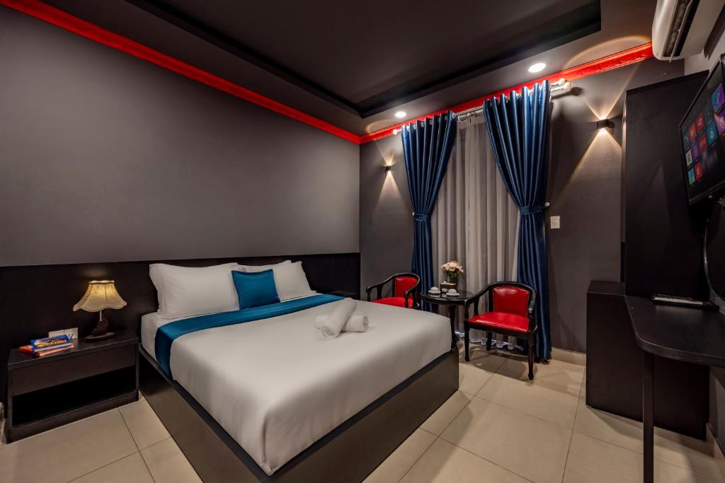 a hotel room with a bed and a television at Hotel Trung Mai-Sân Bay in Ho Chi Minh City