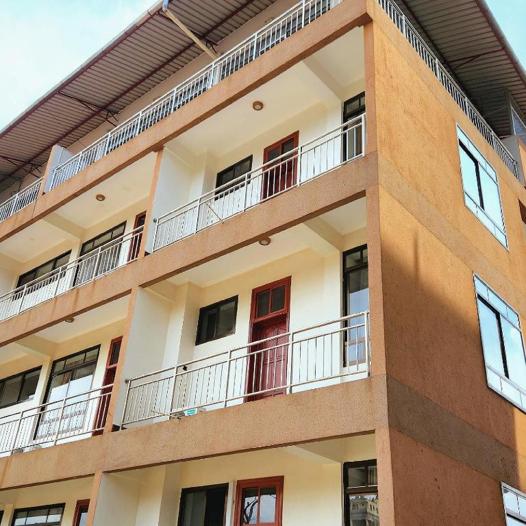 an external view of a building with balconies at Kilimanjaro Magic in Moshi