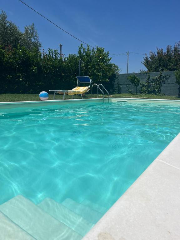 a swimming pool with a chair and a frisbee in it at Villetta di Laura in Villa San Leonardo