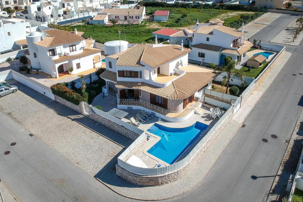 an aerial view of a house with a swimming pool at Villa Brisa do Mar by Algarve Holidays in Galé