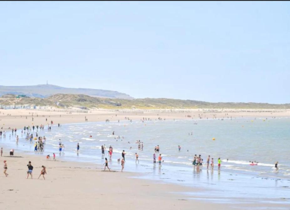 a group of people on a beach in the water at La casa valentine in Calais