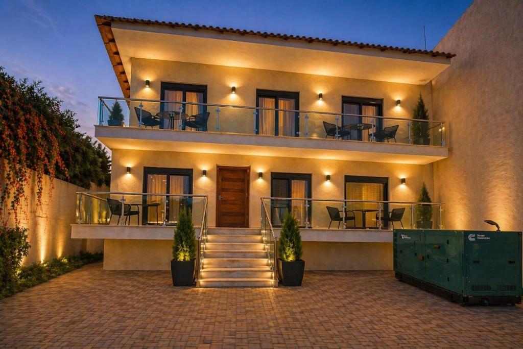 a building with a balcony with chairs on it at Vero Mare in Pefkochori